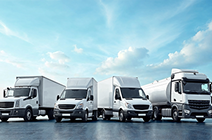 White commercial fleet parked under blue sky